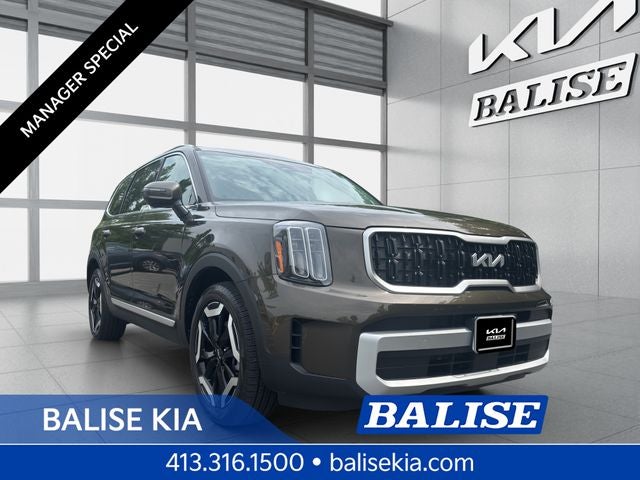 2025 Kia Telluride EX in Dark Moss — front three-quarter view